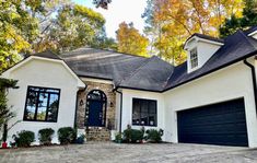 a white house with black doors and windows