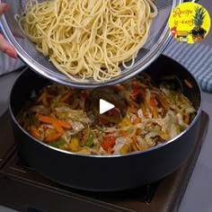 someone is holding a bowl with noodles and vegetables in it while another person holds the lid