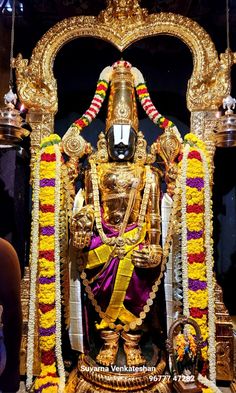 the statue is decorated in gold and purple