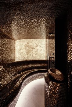 a very fancy bathroom with mosaic tile on the walls