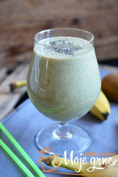 a smoothie in a glass on a table next to bananas