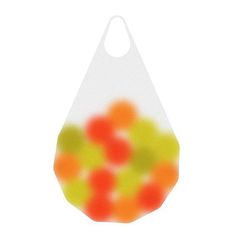 an orange and green bag filled with lots of gummy balls on a white background