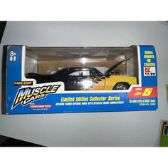 a yellow and black toy car in a box