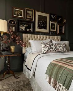 a bedroom with pictures on the wall above the bed