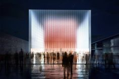 people are standing in front of a building with a large red object on it's side