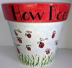 a painted flower pot with the words how does it? written in black and red