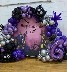 purple and black balloon arch with halloween decorations