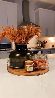 a black vase sitting on top of a kitchen counter