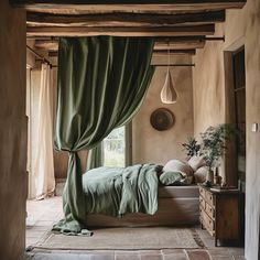 a bed sitting under a window next to a wooden dresser