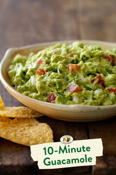 guacamole in a bowl with tortilla chips on the side