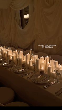 a long table with many lit candles on it