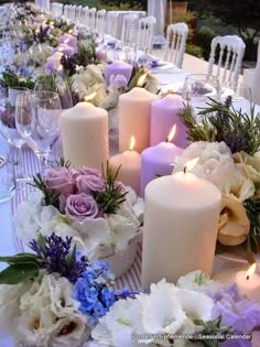 the table is set with candles and flowers