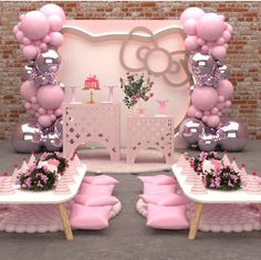 a table with pink pillows and balloons on it