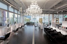 an empty salon with chandelier and chairs in the middle, looking into the room