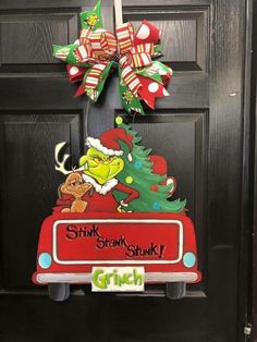 the grinch door hanger is decorated with christmas decorations