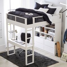 a white bunk bed with black sheets and pillows