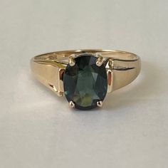 Exquisite 14K Yellow Gold Green Topaz Ring, Size 7.25, 2.58 grams Size: 7.25 Weight: 2.58 grams Main Stone: Green Topaz  Size Stone: ca. xxmm x xxmm Color: Stunning Forest Green Marking: 14K, TRI Gold: Solid 14 Karat Yellow Gold Band Width: ca. xxmm  Tested: PRESIDIUM (C) Duo Tester II, Thermo Scientific Niton DXL Precious Metal Analyzer - tested 14.04KT (testing performed by 3rd party) Condition: Very good preowned- light wear out throughout. Refer to picture for condition. All jewelry will be professionally cleaned before shipping and come in a beautiful little gift box. Returns accepted but are subjected to a 8% restock fee. Returns are only accepted for national orders and in original packaging. Green Topaz, Topaz Ring, Gold Bands, Precious Metals, Little Gifts, Rings Statement, Topaz, Statement Rings, Jewelry Rings