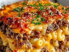 a slice of lasagna casserole on a plate with cheese and meat