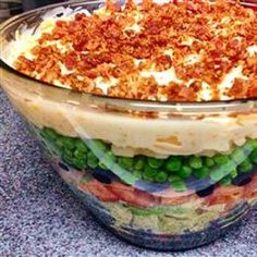 a large glass bowl filled with food on top of a table