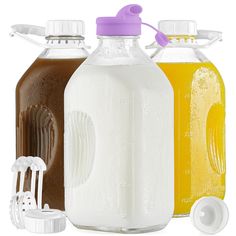 three different types of juice bottles with lids and spoons next to each other on a white background