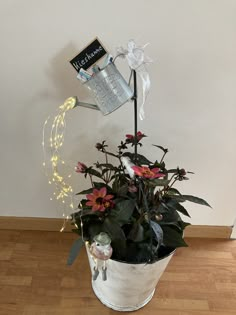 a potted plant with flowers and lights in it