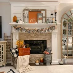 a living room filled with furniture and a fire place covered in pumpkins on top of it