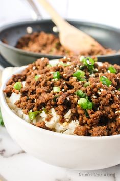 two bowls filled with ground beef and rice