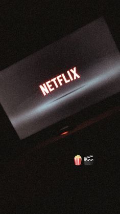 the netflix logo is lit up in the dark