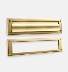 two brass door handles on a white background