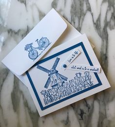 two greeting cards, one with a windmill and the other with a bicycle on it