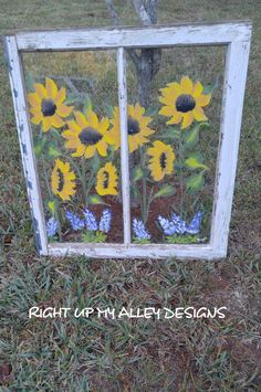 an old window with sunflowers painted on it