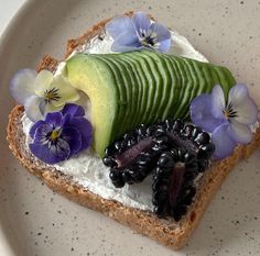 a piece of bread with fruit and flowers on it