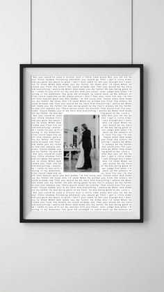 a black and white photo hanging on the wall next to a frame with words written in it