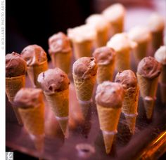 several cones of ice cream with chocolate toppings on them are arranged in a row