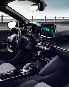 the interior of a modern car with dashboard, steering wheel and touch screen display showing