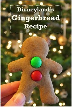 a hand holding up a gingerbread cookie with the words disneyland's gingerbread recipe on it