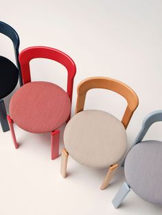 four different colored chairs sitting next to each other