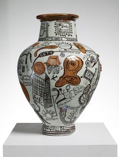 an artistic vase is on display in the book's page, and it appears to have been altered