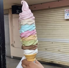 a person holding an ice cream cone in their hand