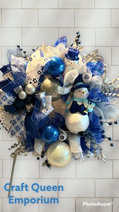 a blue and white christmas wreath with snowmen