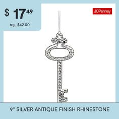 a silver antique finish rinestone key ornament with the price $ 17 99