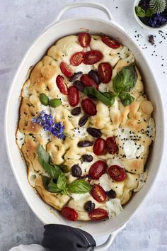 a pot filled with pasta and vegetables on top of a table