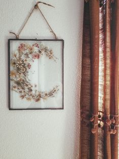 a frame hanging on the wall next to a window