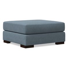 a blue footstool sitting on top of a white floor