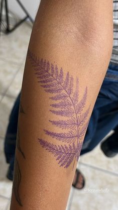 a close up of a person with a tattoo on their arm