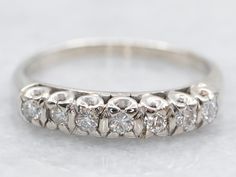 an antique diamond wedding ring on a white background