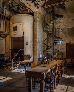 an old building with stairs and tables in it