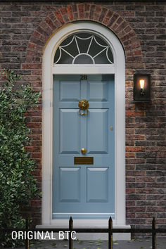 a blue front door on a brick building