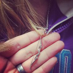 a person holding some kind of metal object in their hand with chains on it's fingers