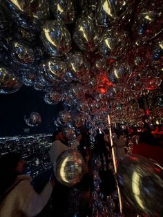 many shiny balls are hanging from the ceiling